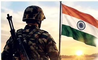 A soldier on duty at sunrise beside the Indian flag